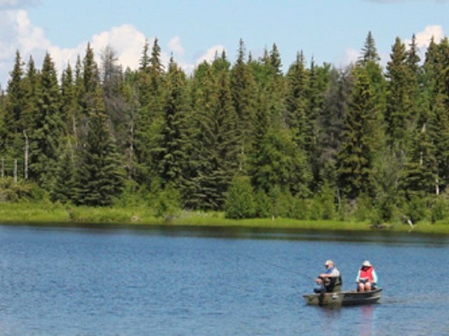 two campers fishing on Ole's lake in Grande Prairie region 