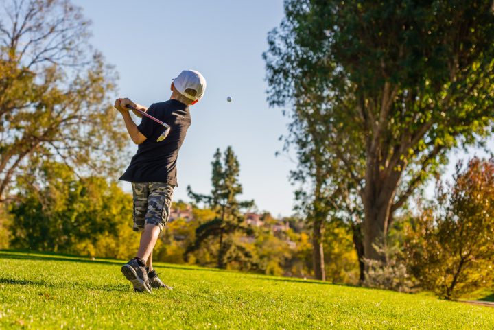 south bear creek - little boy golfer teeing off on a sunny day