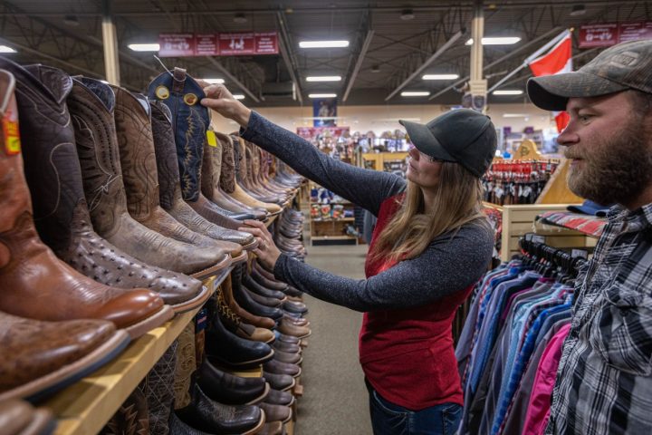 Woman shopping for cowboy boots in the Grande Prairie Region