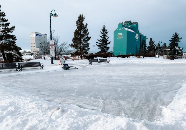 Sesmith Community Ice Rink with a grain elevator in the background.