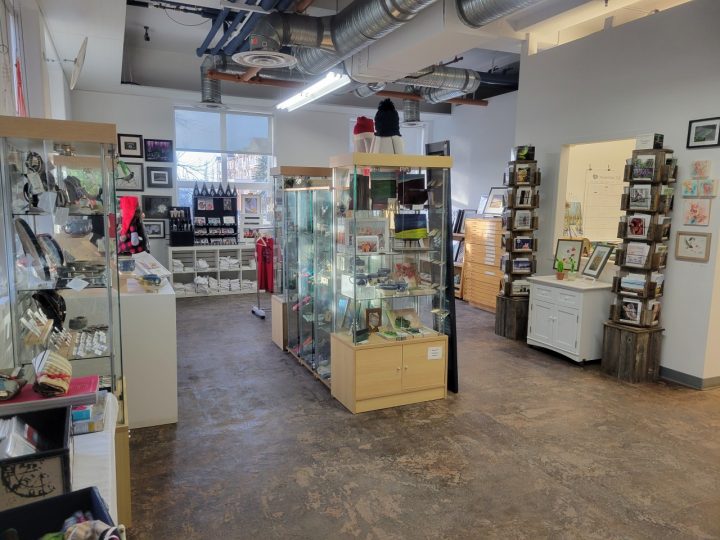 Display cases and shelves featuring local artwork and crafts at the Centre for Creative Arts in Grande Prairie