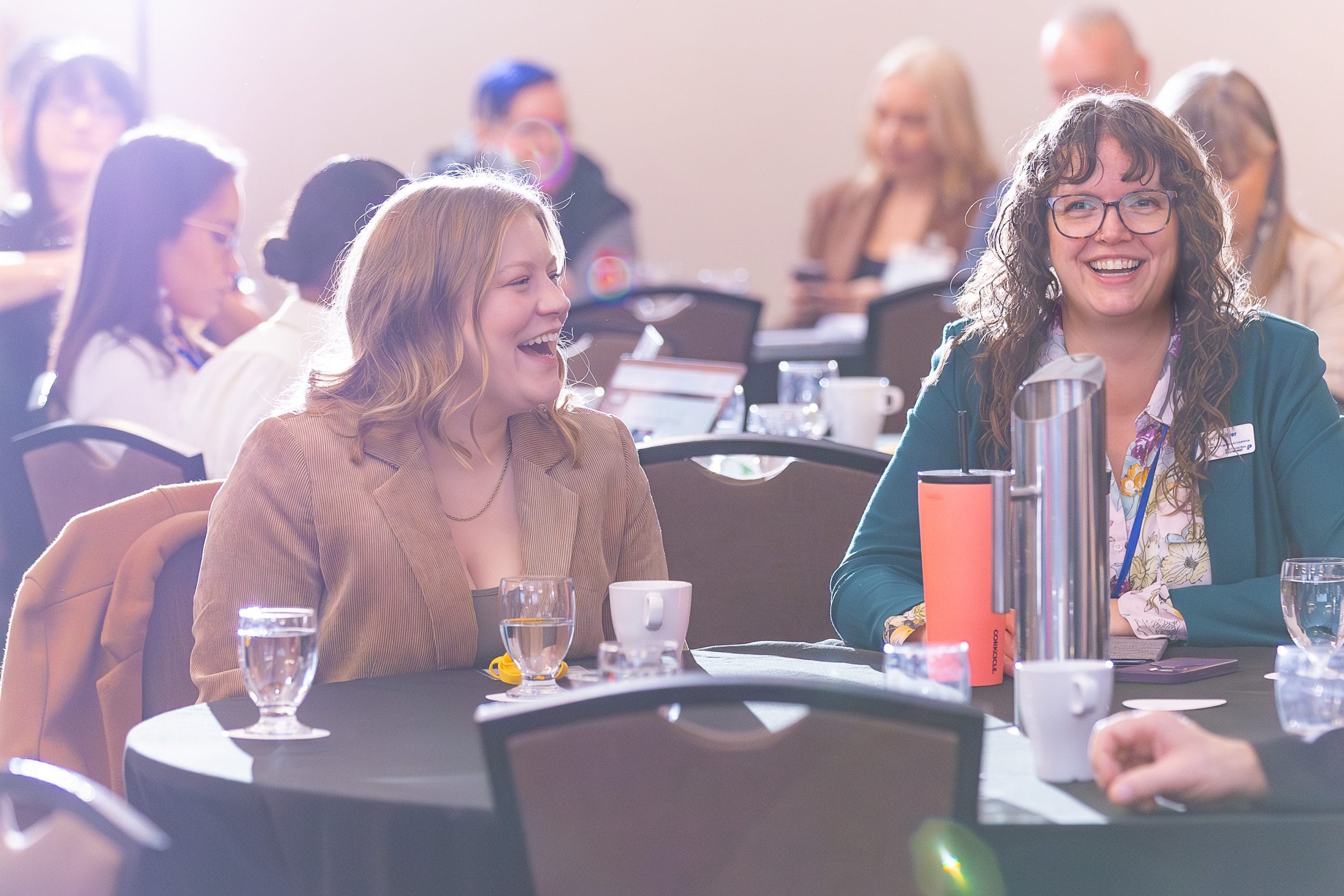 Women laughing at a business conference
